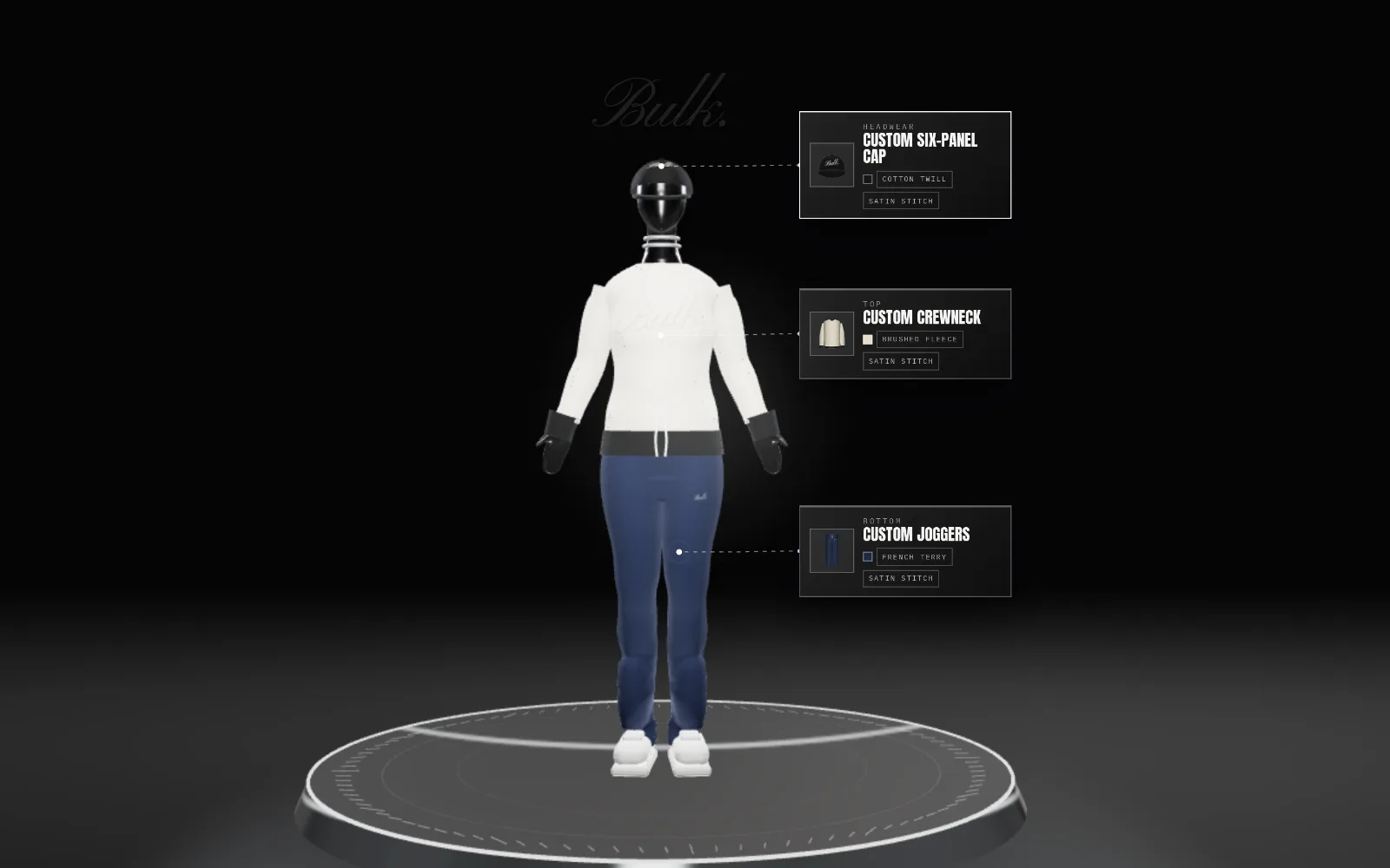 The BULK. studio: a 3D mannequin on a glass turntable, wearing a cap, a cream crewneck and navy joggers
